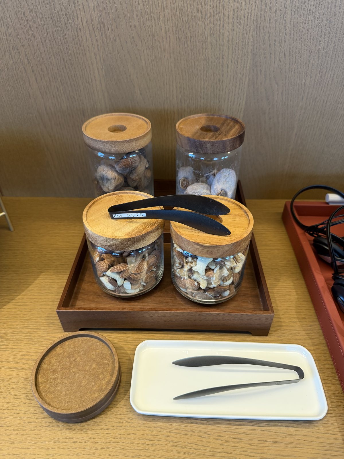 コンラッド名古屋32階フィットネスエリアの軽食。木の蓋つきガラス瓶に入ったいちじく、干し柿、ナッツ2種