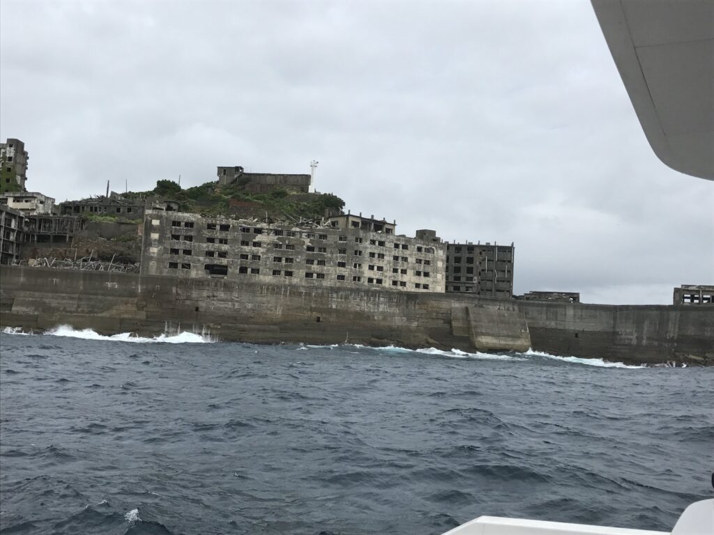 灯台のある軍艦島の端と、白波の立つ海